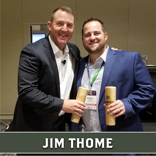 Jim Thome posing beside another man, both holding wooden Dugout Mugs baseball bat mugs.